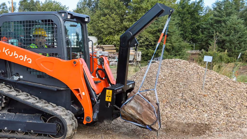 Loader boom attachment with lifting arm and hook.