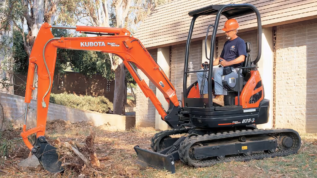 Orange Kubota excavator with tracked undercarriage and digging arm.