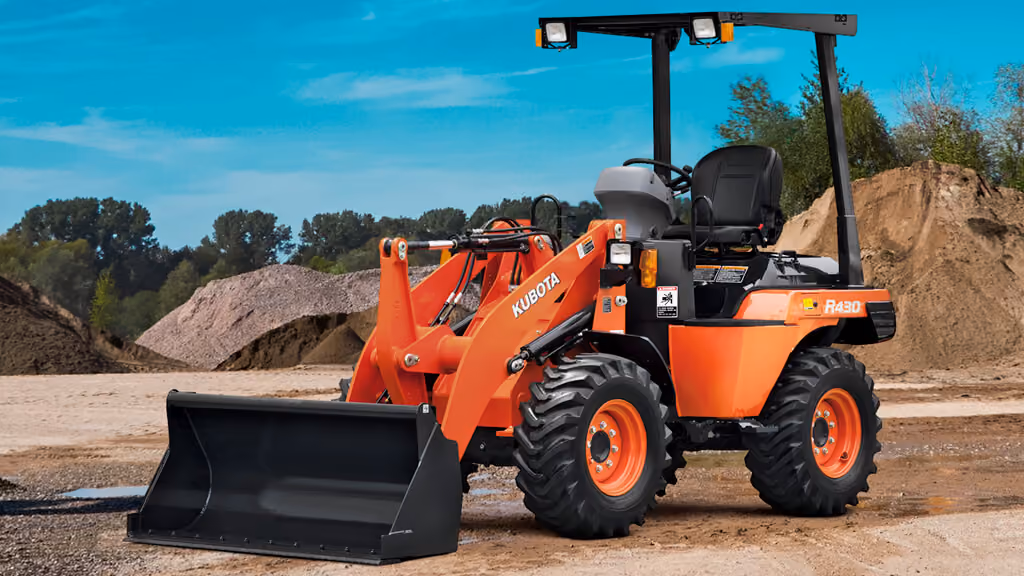 Orange Kubota wheel loader with front bucket.