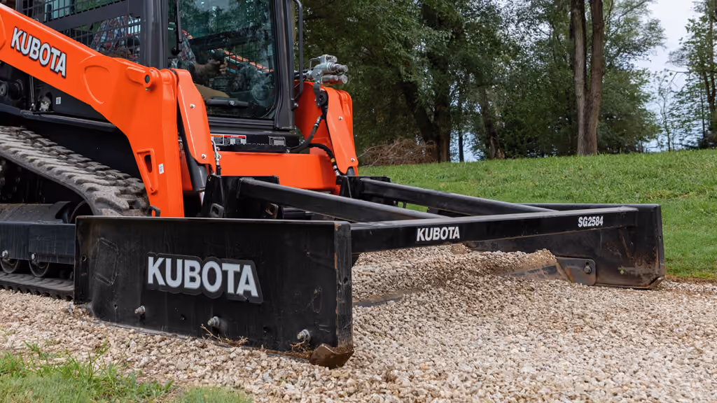 Orange grading attachment with wide steel blade.