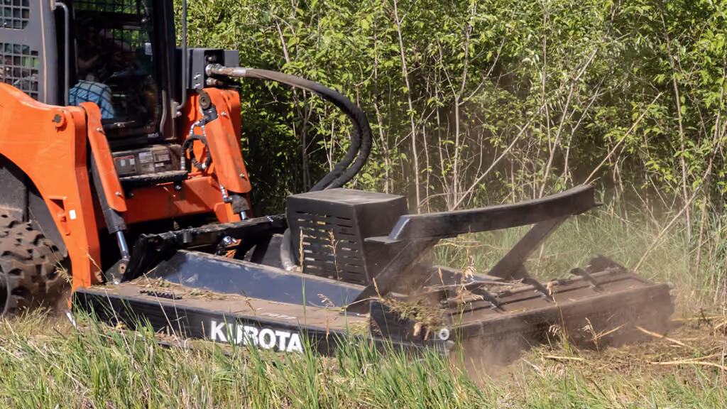 Orange rotary cutter attachment for pasture and field mowing.
