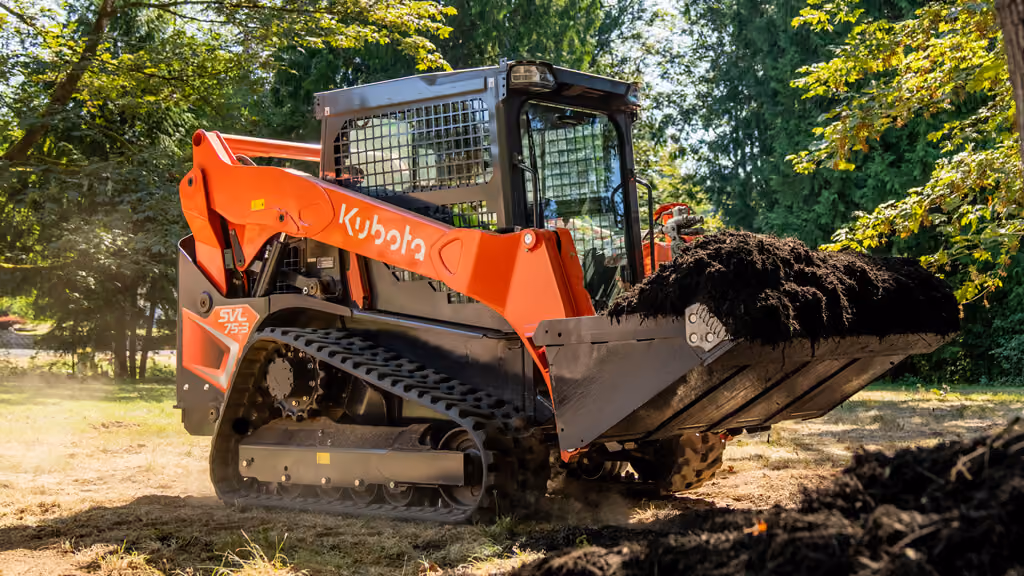 Orange Kubota compact track loader with front bucket.