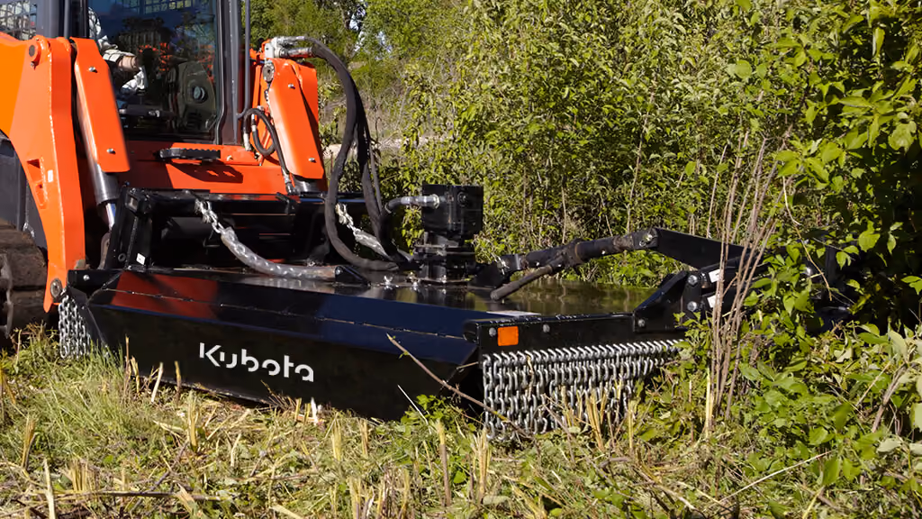 Orange rotary cutter attachment for pasture and field mowing.
