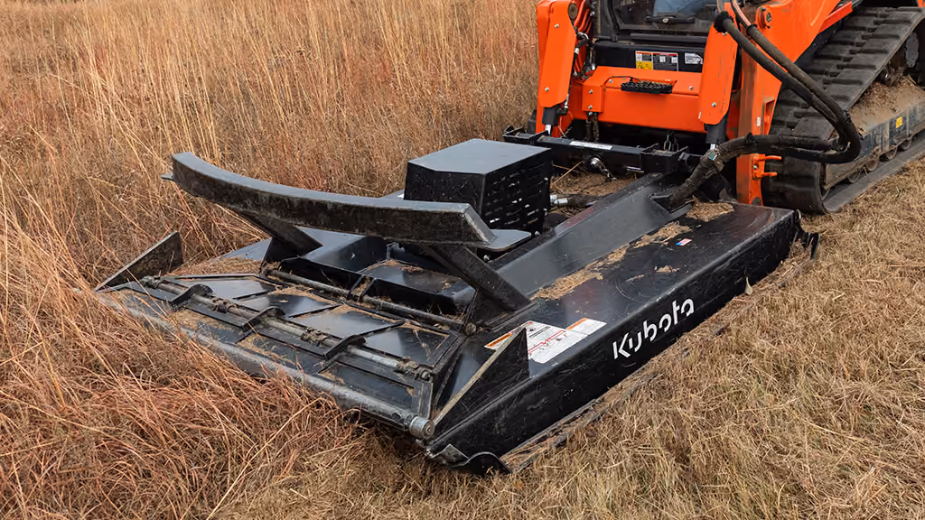 Orange rotary cutter attachment for pasture and field mowing.