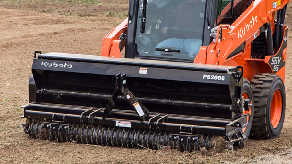 Orange seeder attachment for preparing and planting soil.