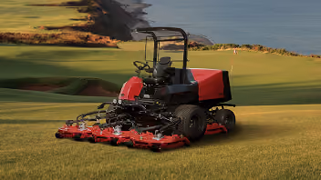 Orange Kubota mower with cutting deck.