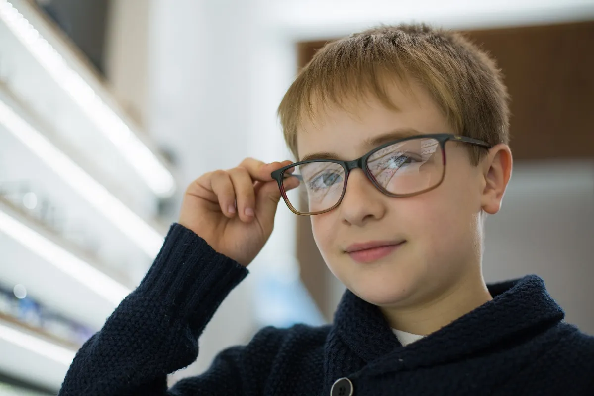 Young boy trying on glasses at Neil Gordon Opticians