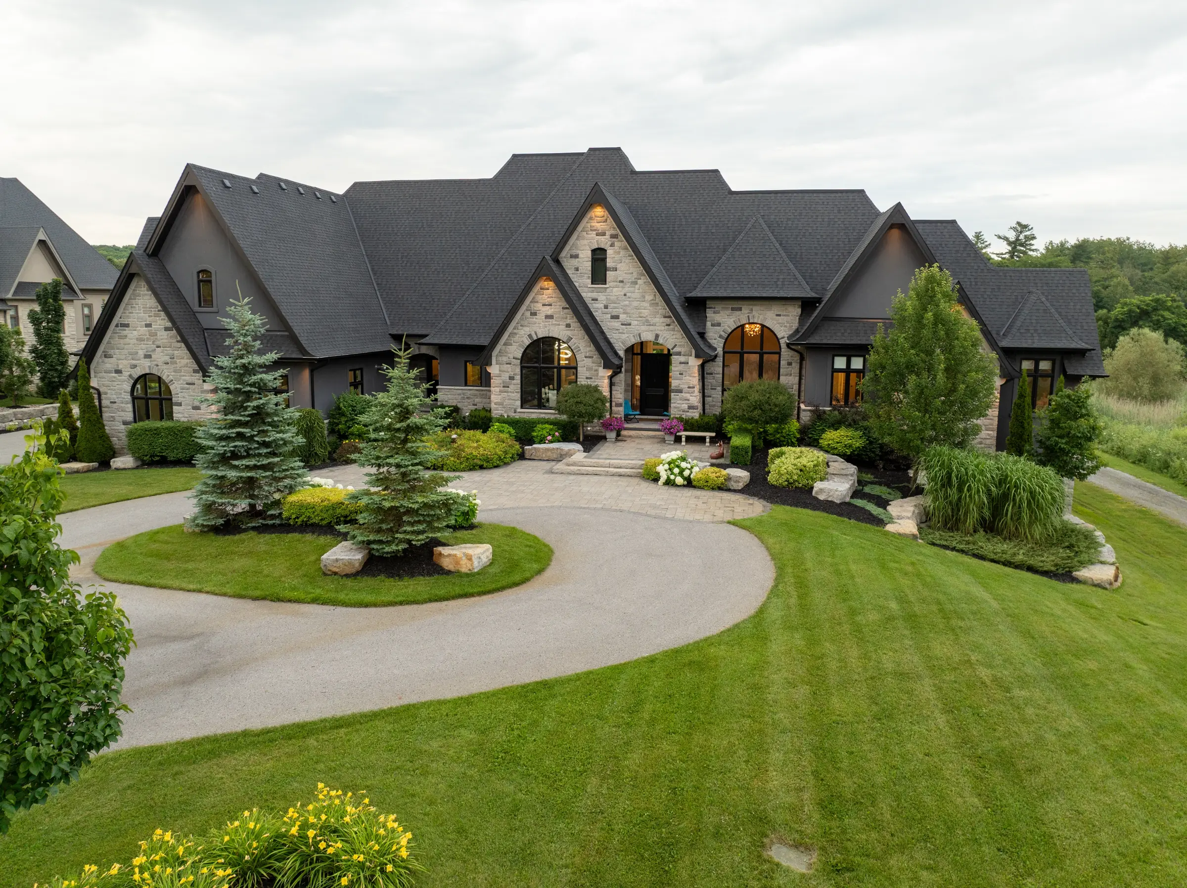 Large stone estate home with landscaped grounds in the Greater Toronto Area