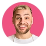 Smiling young man with short blond hair and stubble on a pink background.