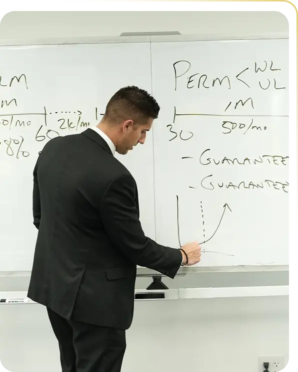 Man in black suit writing on whiteboard with notes and a graph during a presentation.