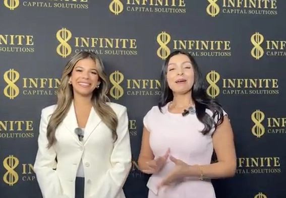 Two women smiling, standing in front of a black backdrop with Infinite Capital Solutions logos.