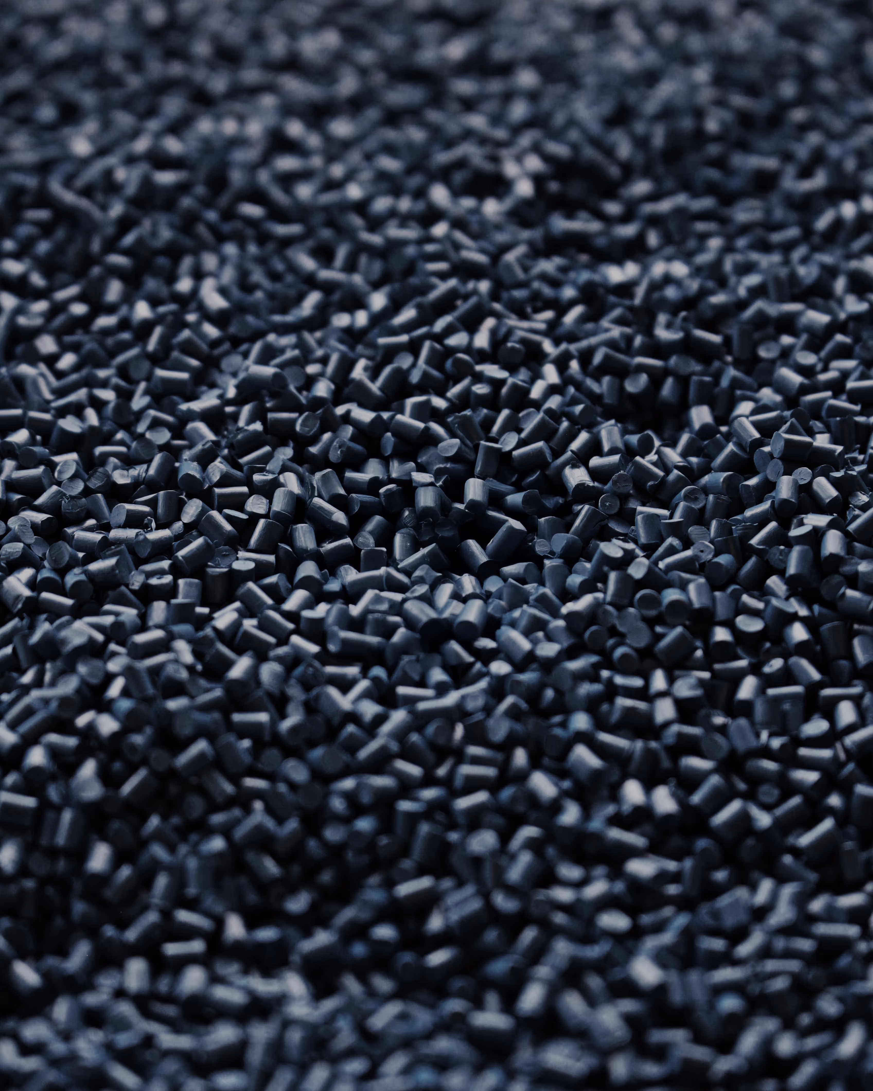 Close-up of recycled polymer pellets — raw material for EECOFF sustainable textile yarn production