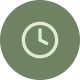 White clock icon inside a green circular background.