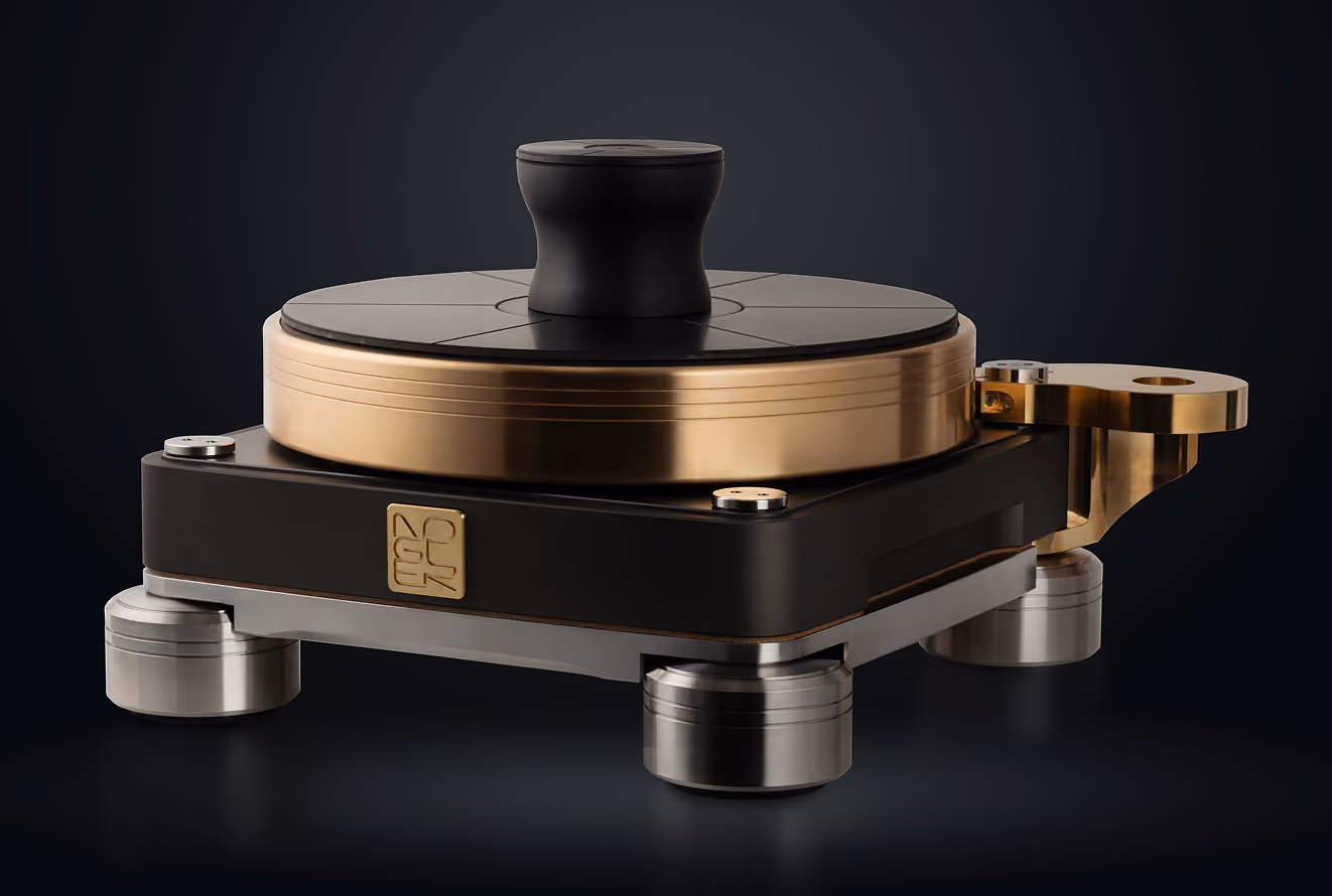 Dispositivo audio hi-fi con base quadrata nera, piedini cilindrici metallici, un disco rotondo dorato e una manopola nera al centro.