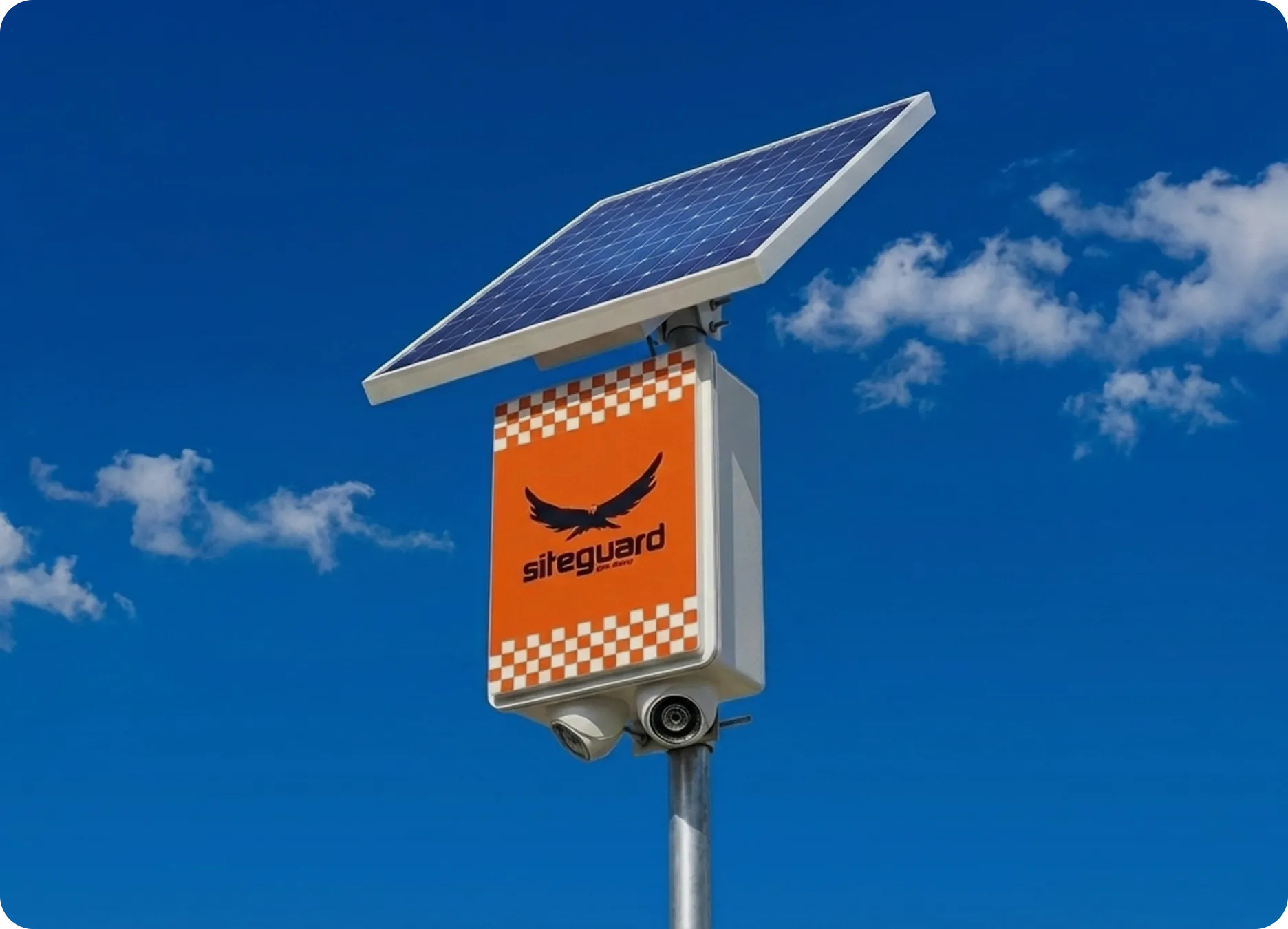 Security camera and Siteguard sign with solar panel against clear blue sky.