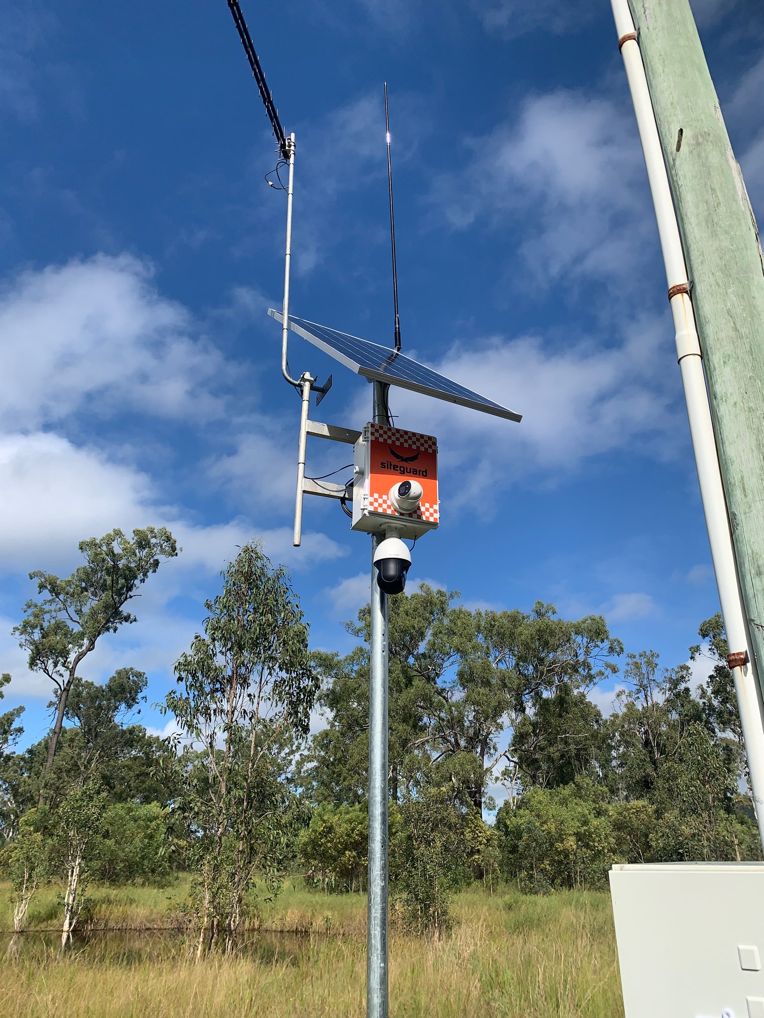 Siteguard solar camera unit with a dome camera and a PTZ camera on a pole at a bush site