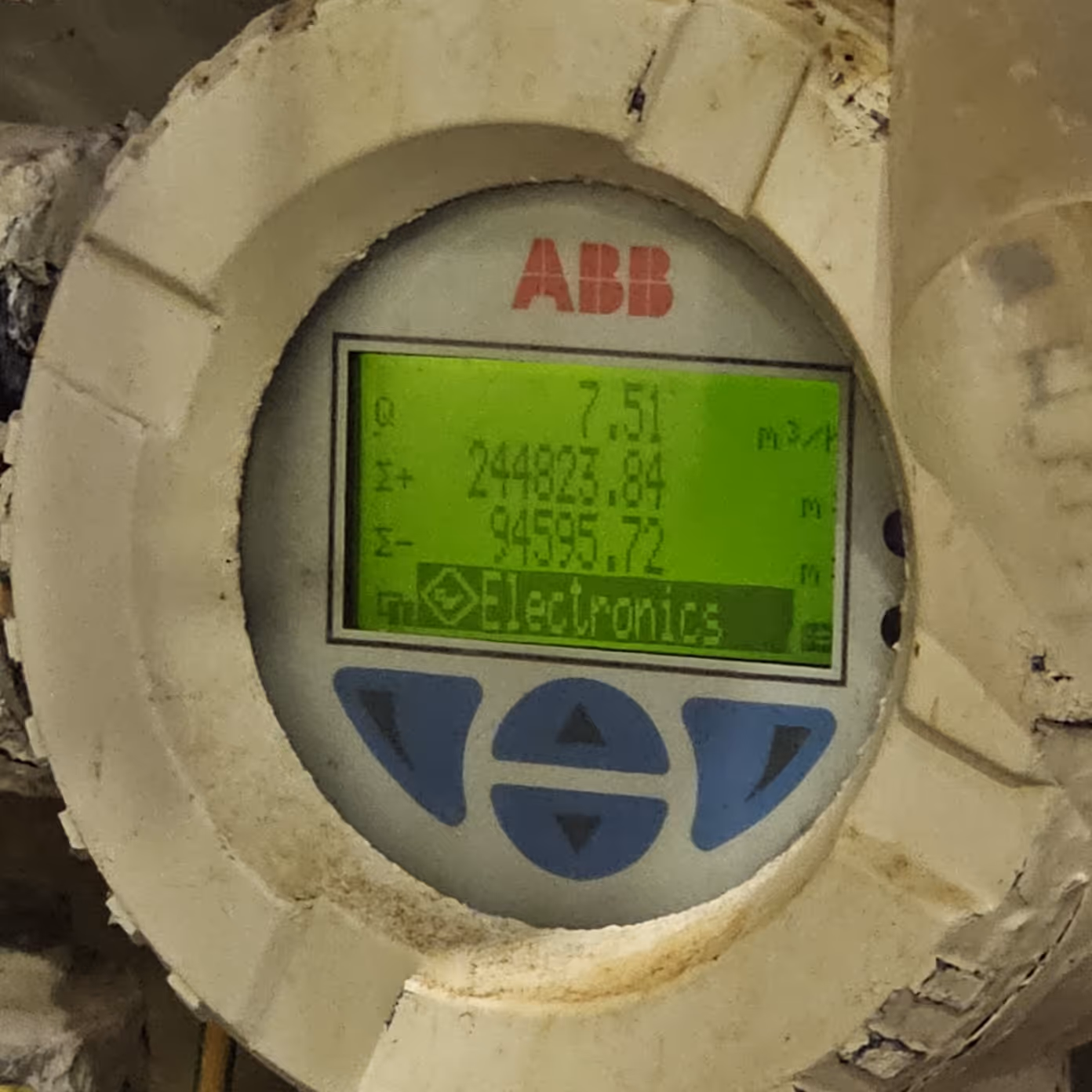 ABB water meter with green digital display showing readings and electronics menu.