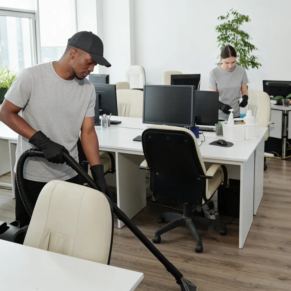 A OK Cleaning team vacuuming and sanitising a commercial office space in Sydney