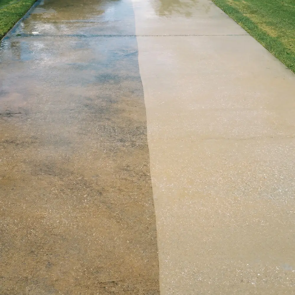 Before and after result of high pressure cleaning on a concrete driveway in Sydney showing the dramatic difference in cleanliness
