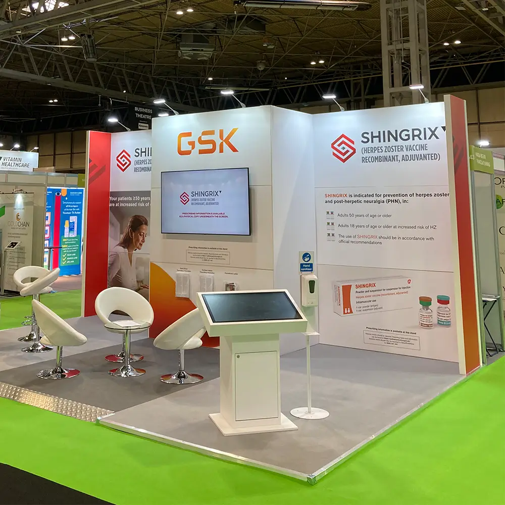 Exhibition booth for GSK's Shingrix herpes zoster vaccine with chairs, screen, and informational panels.