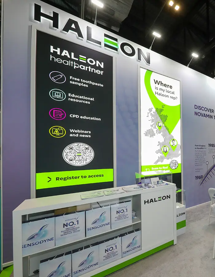 Haleon health partner booth with toothpaste samples, educational resources, and map of local reps.