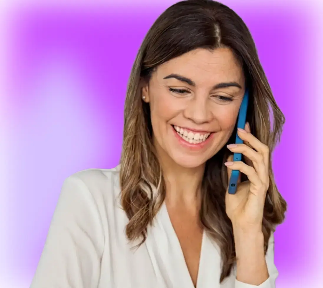 Smiling woman with brown hair talking on a blue smartphone against a purple gradient background.