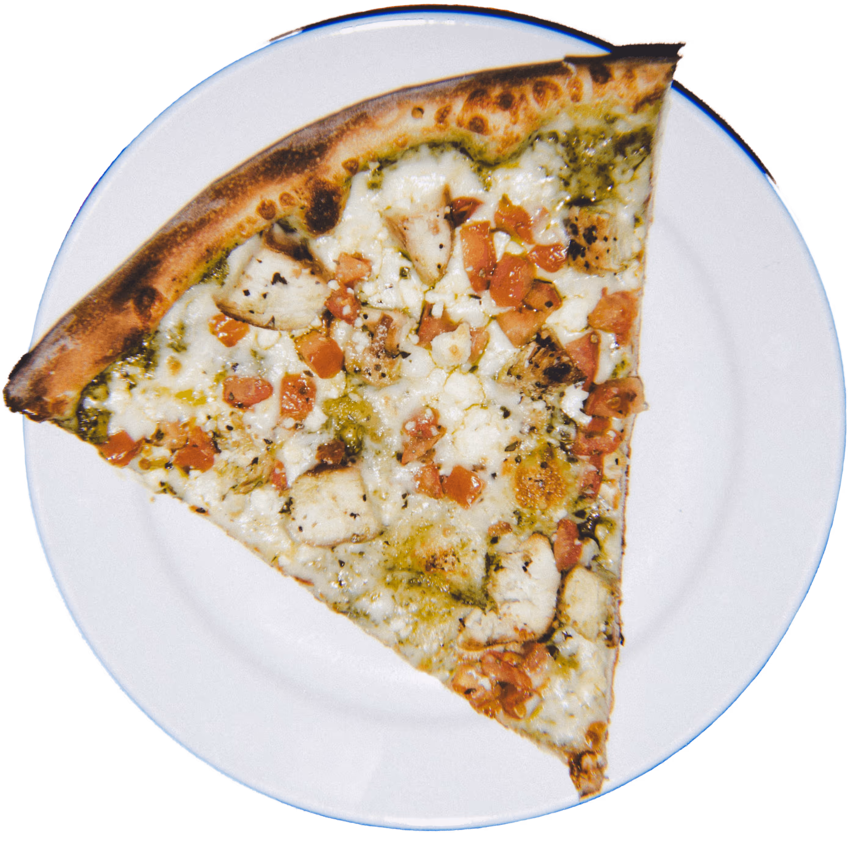 Slice of pizza with chicken, tomato, cheese, and pesto sauce on a white plate.