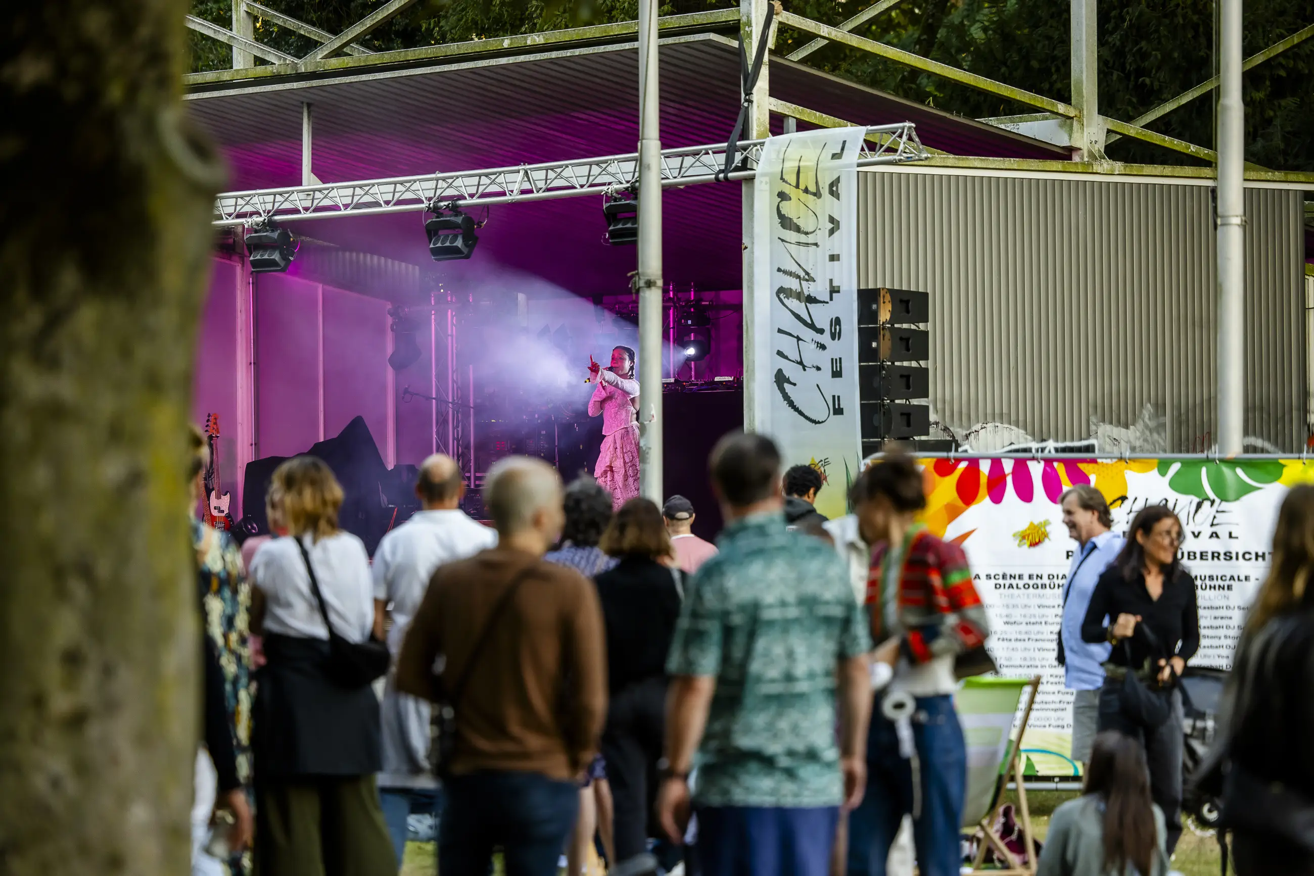 Menschenmenge sieht einer Sängerin zu, die auf einer Bühne beim Chance Festival auftritt.