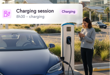A woman standing next to a blue electric car that is charging at a charging station, looking at her phone, with an overlay showing a charging session lasting 8 hours and 30 minutes.