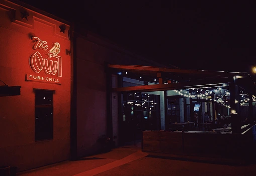 Exterior of The Owl Pub & Grill at night