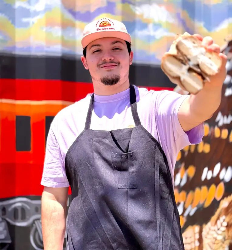 Man holding bagel sandwich