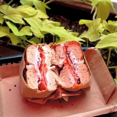 Bagel sandwich cut in half and wrapped in paper