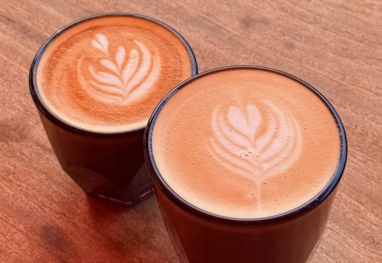 Two coffees with a foam art design