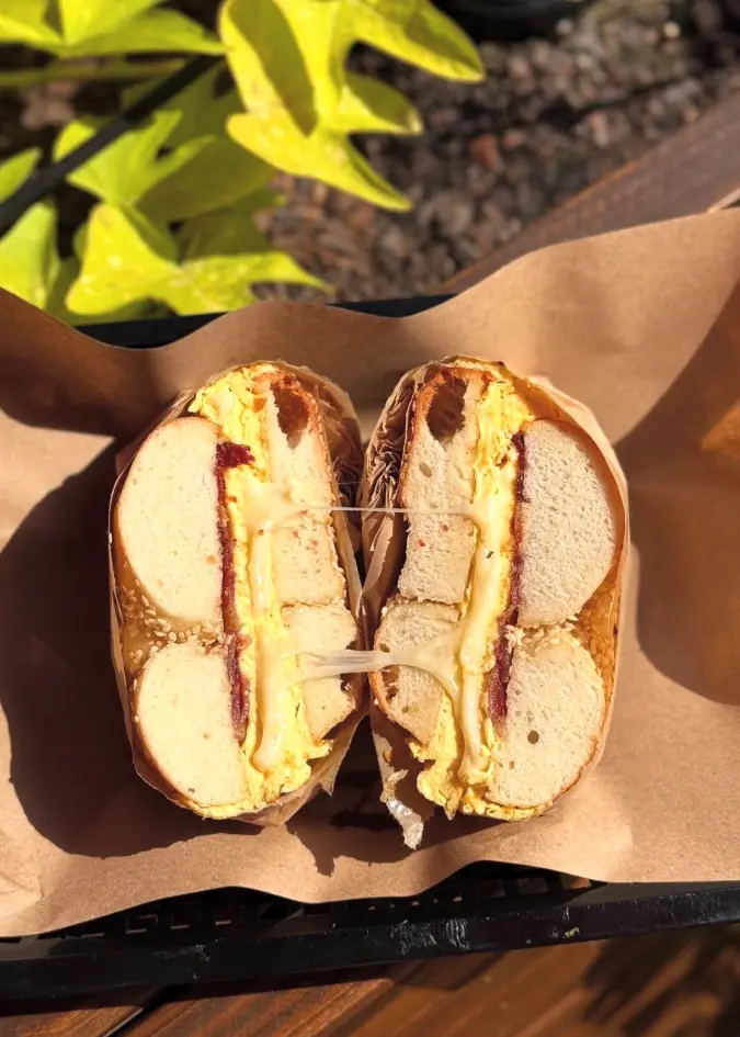 Bagel sandwich cut in half and wrapped in paper