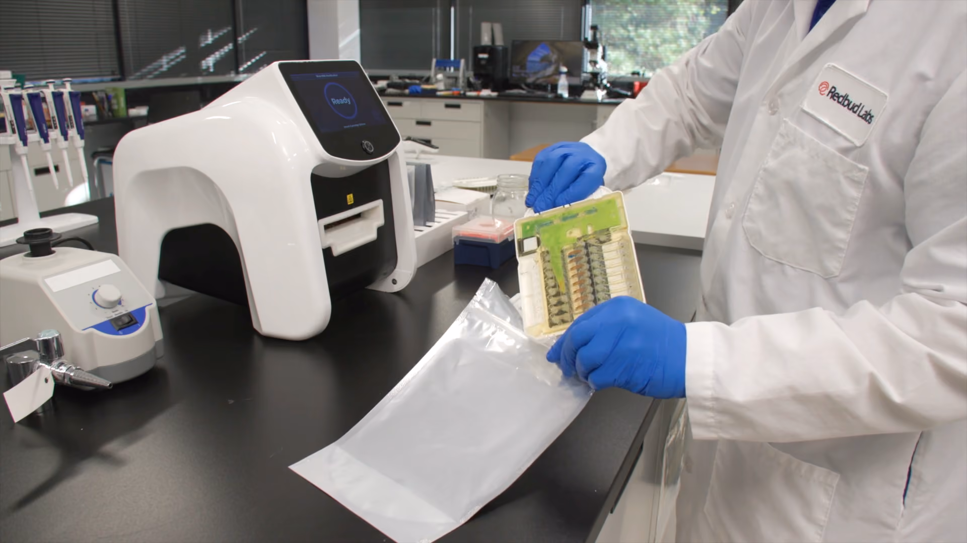 A scientist disposing of waste material from Redbud NA1