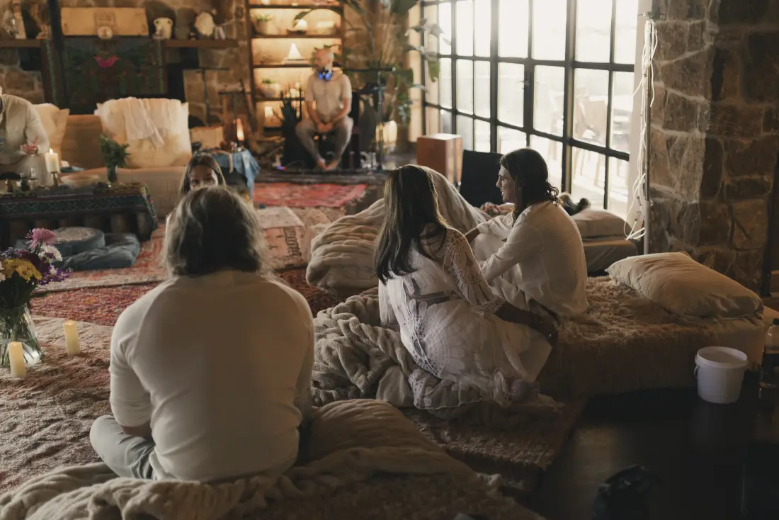 Participants dressed in white sitting together in the ceremony hall