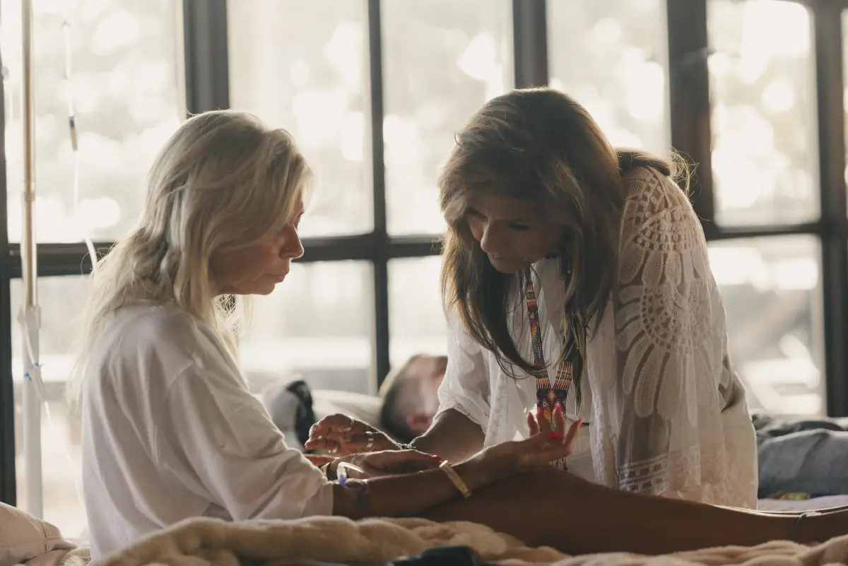 A guide sits closely with a participant during ceremony at our Texas sanctuary