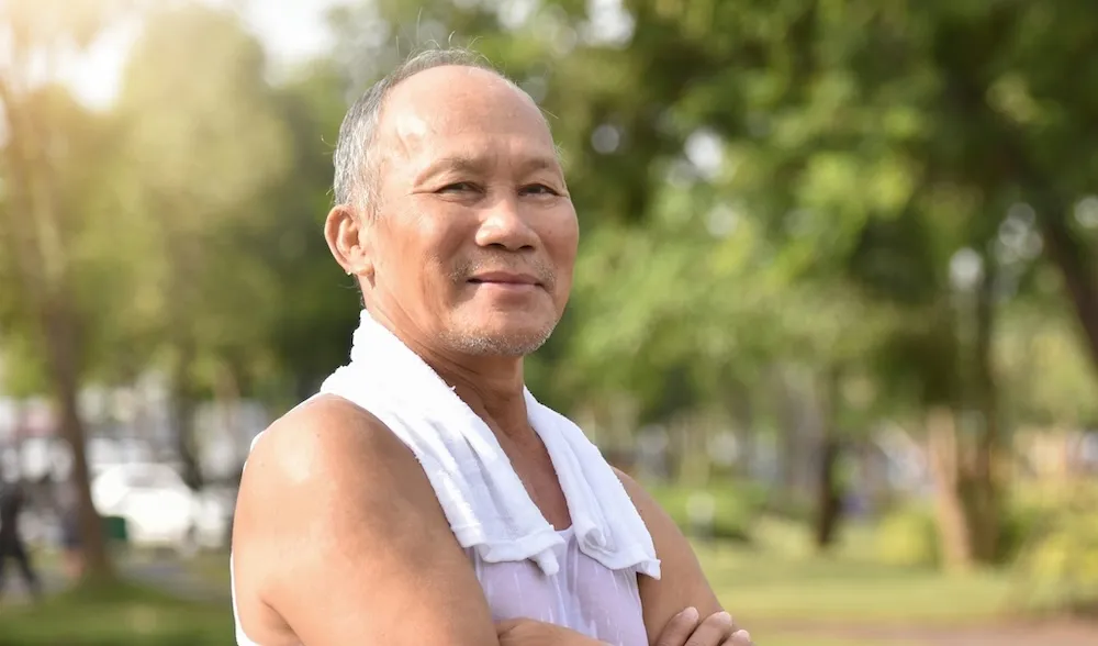 An image of a man smiling in his gym clothes. 