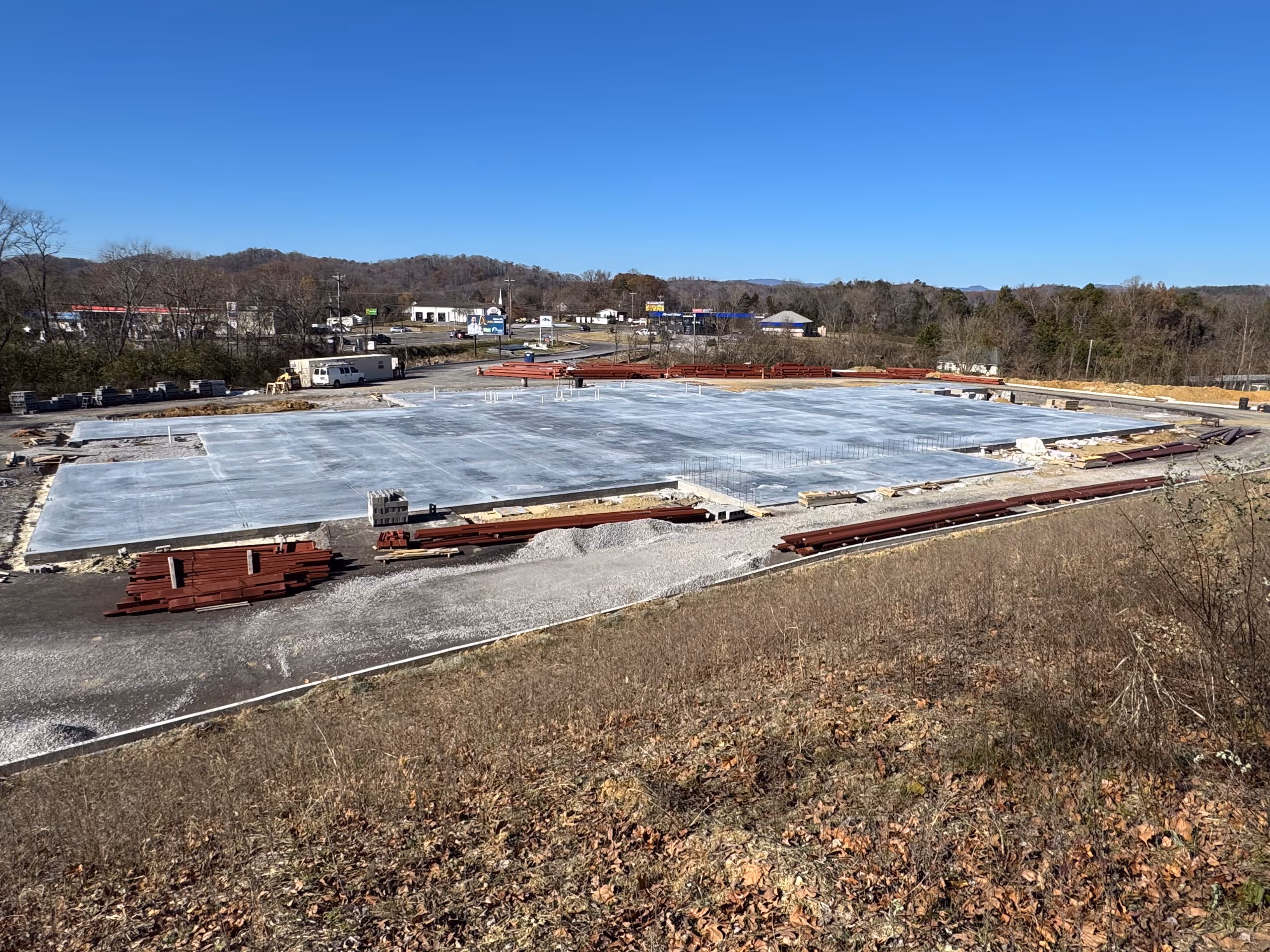 An empty parking lot with a large building in the background.