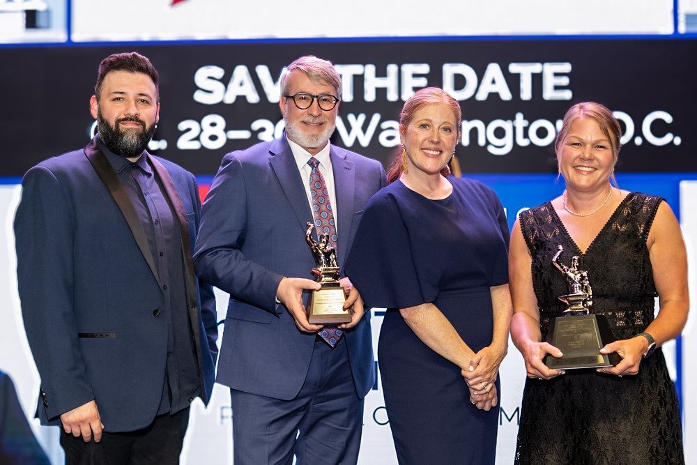 PRR and Washington State Department of Ecology team members accepting the PRSA Silver Anvil Best of Show award on stage