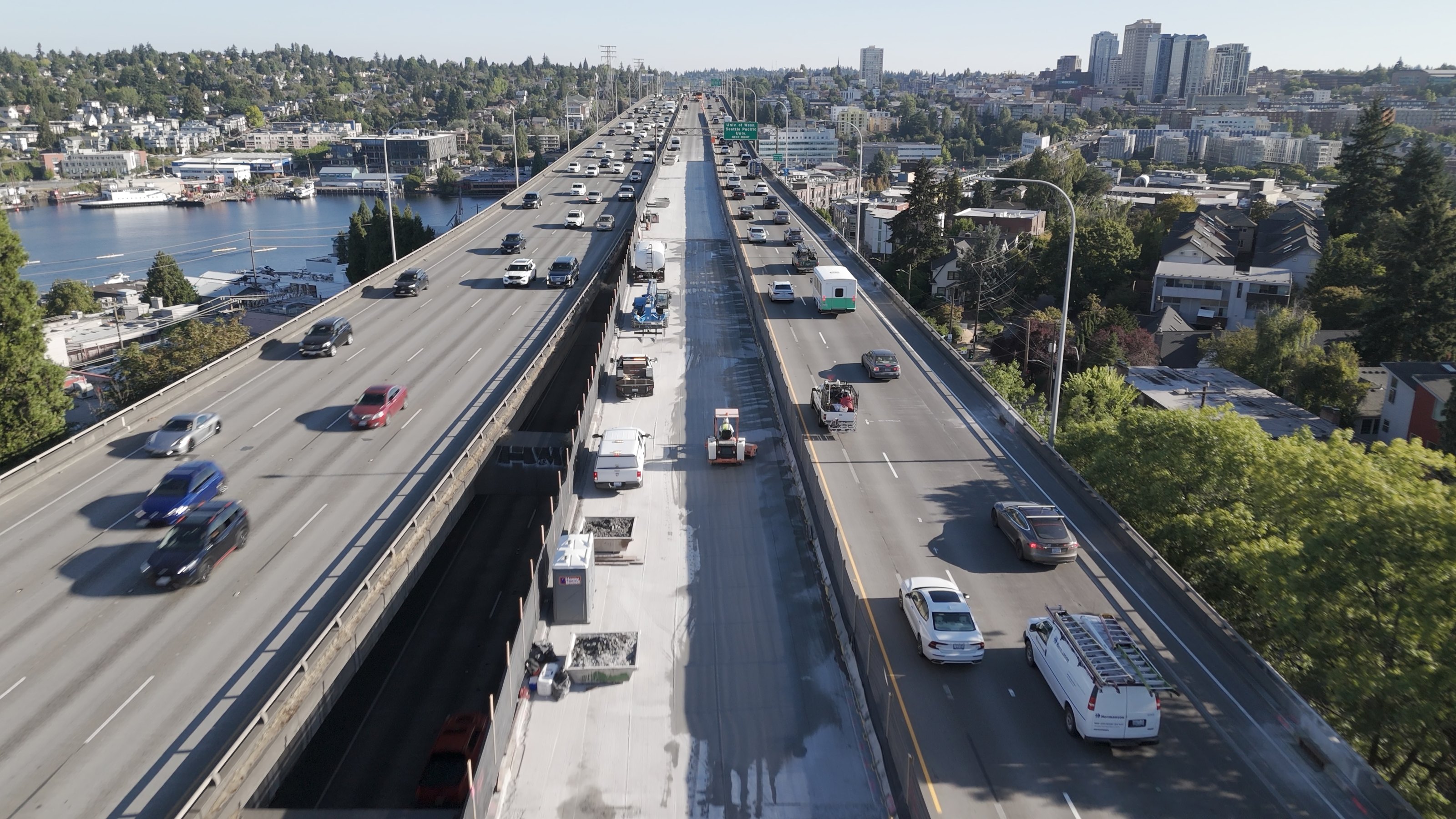 Aerial view of I-5 construction crews working between lanes of live traffic on the Ship Canal Bridge in Seattle