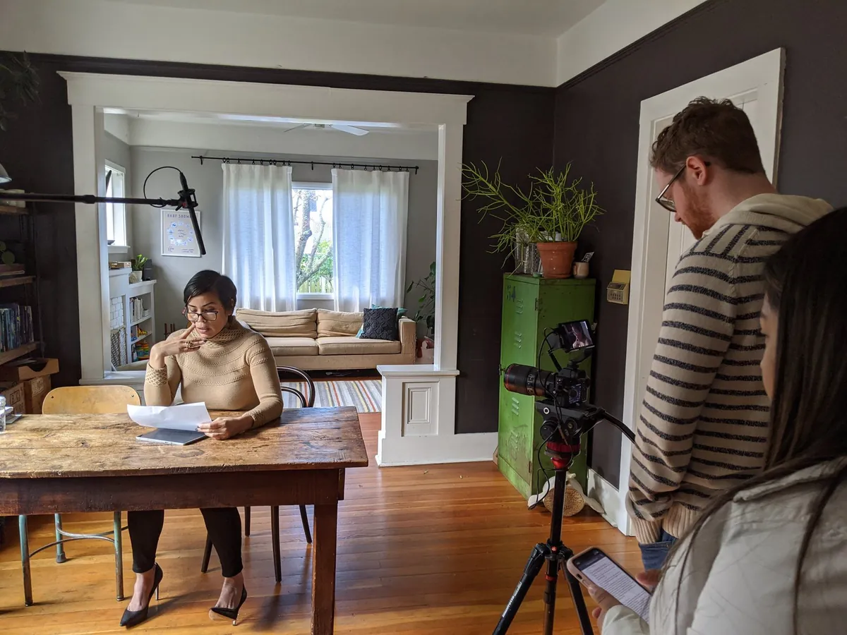 PRR crew filming a video shoot for the Washington State Department of Health Rx opioid awareness campaign, with a speaker reading from a script at a dining table.