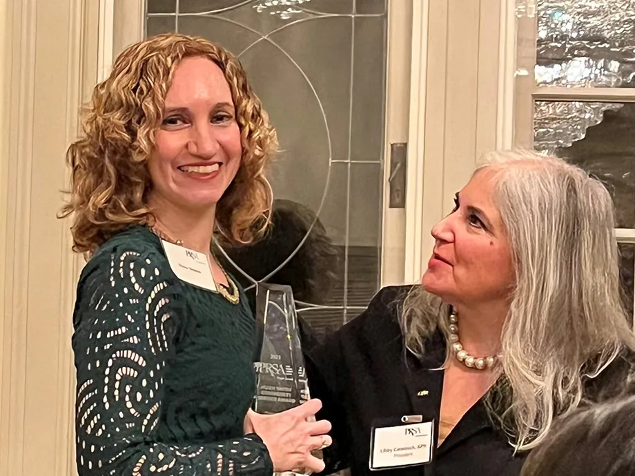 Diana Steeble accepts the Hugh Smith Community Service Award from Libby Catalinich, outgoing president of PRSA Puget Sound.