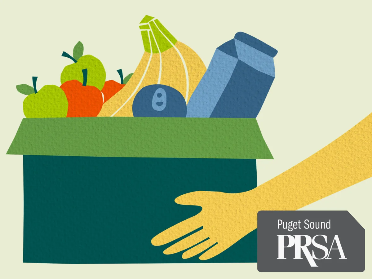 Paper-cut style illustration of a hand holding a green box of groceries, with apples, bananas, and a milk carton, and the PRSA Puget Sound logo in the corner.