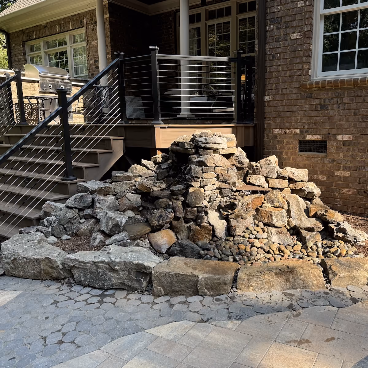 Custom landscape waterfall creating a relaxing outdoor space