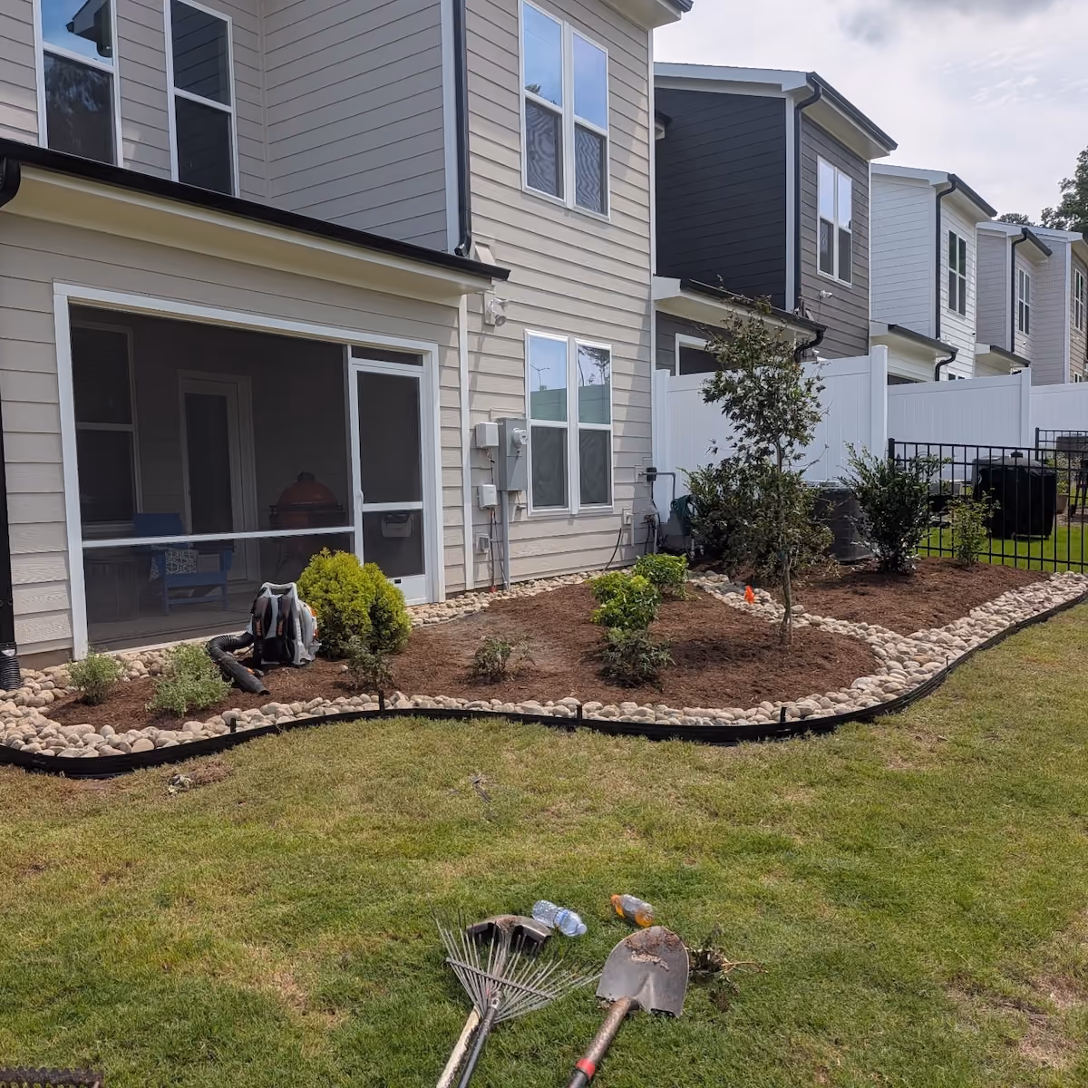 Custom front yard landscaping with shrubs and ornamental plants