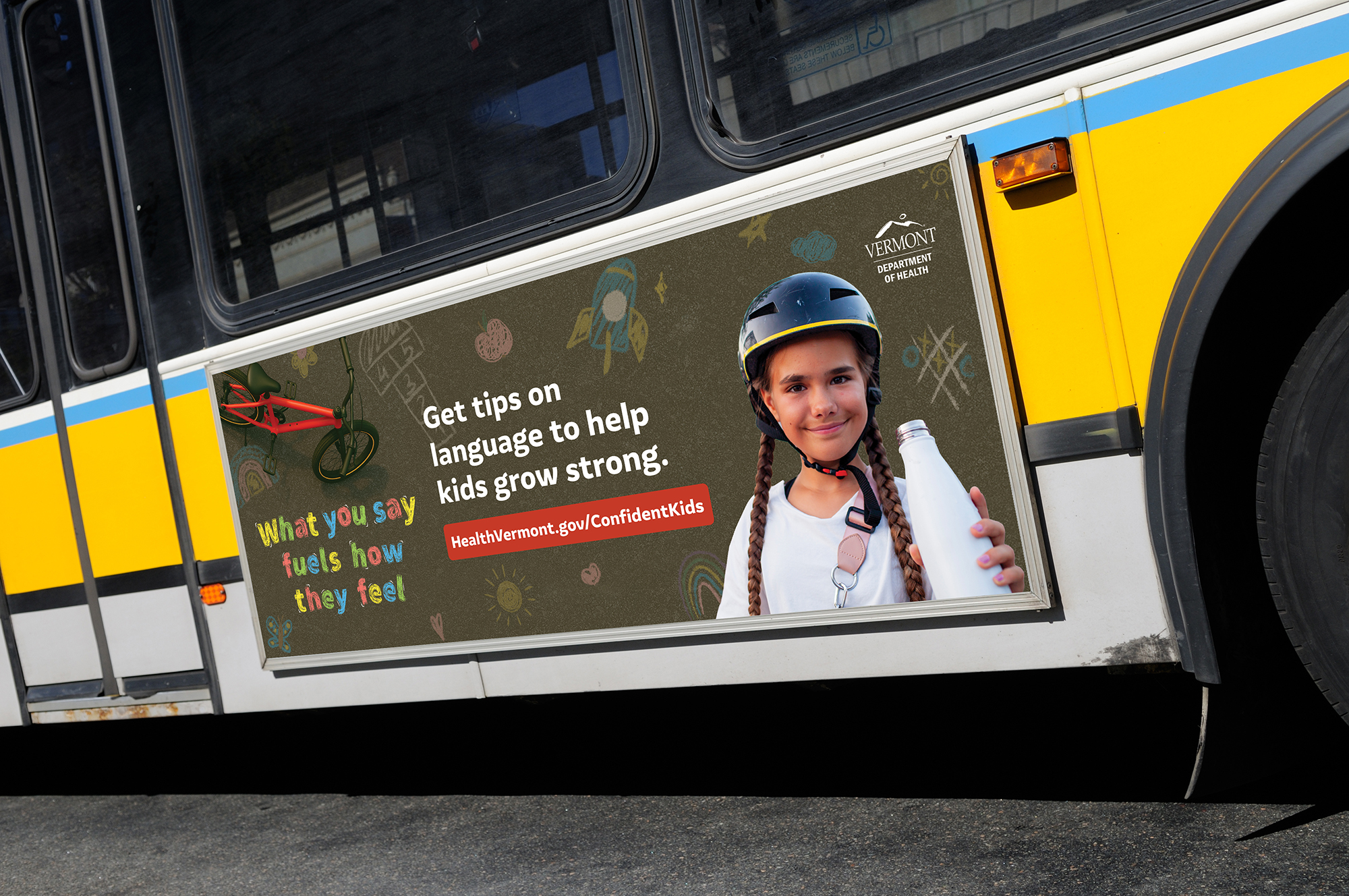 Bus side ad showing a girl in a bike helmet with the message Get tips on language to help kids grow strong