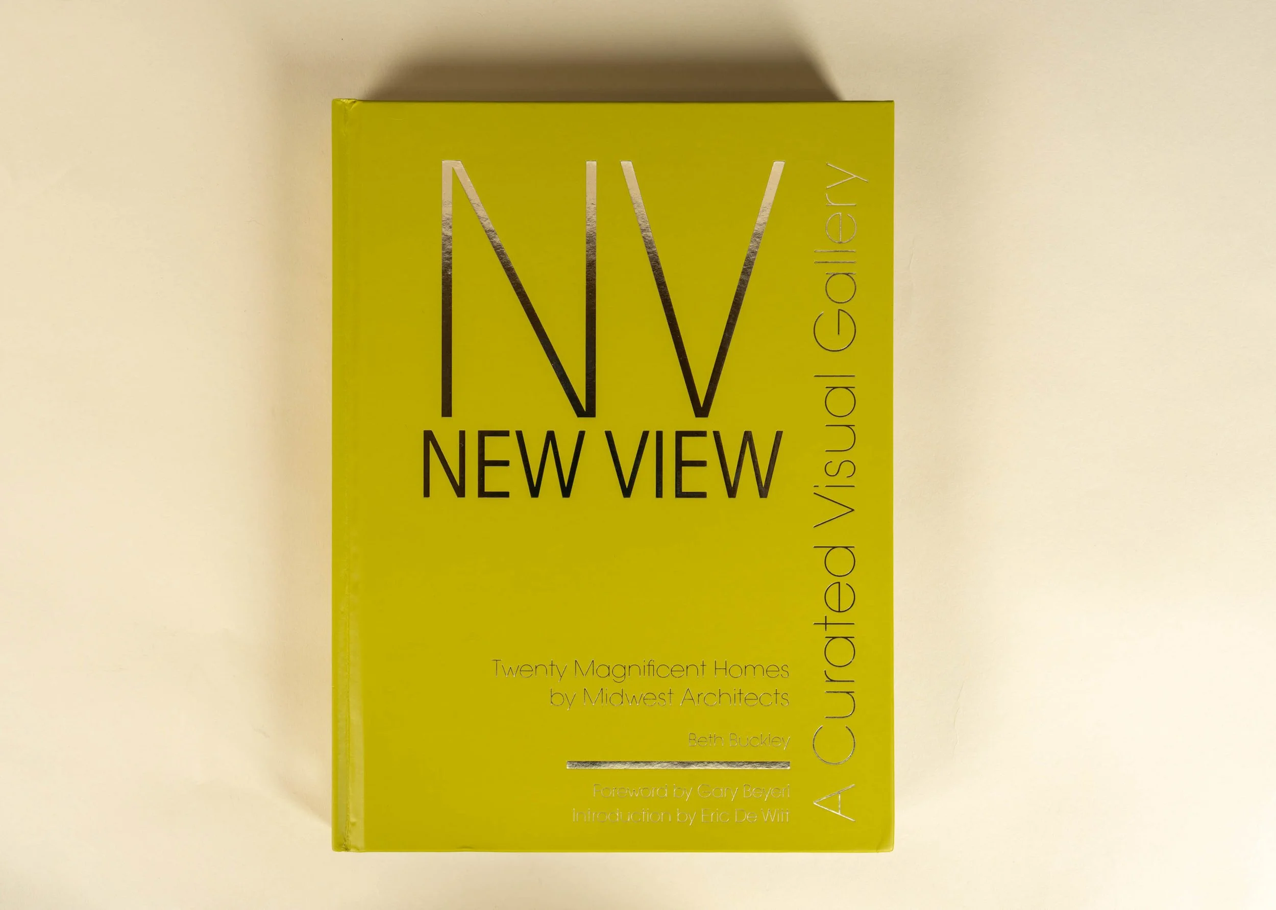 Yellow book titled 'NV NEW VIEW A Curated Visual Gallery' about Midwest architects.