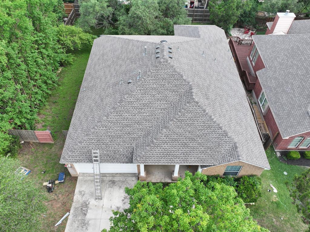 Aerial view of the completed commercial shingle roof at Sunbridge Inn & Suites