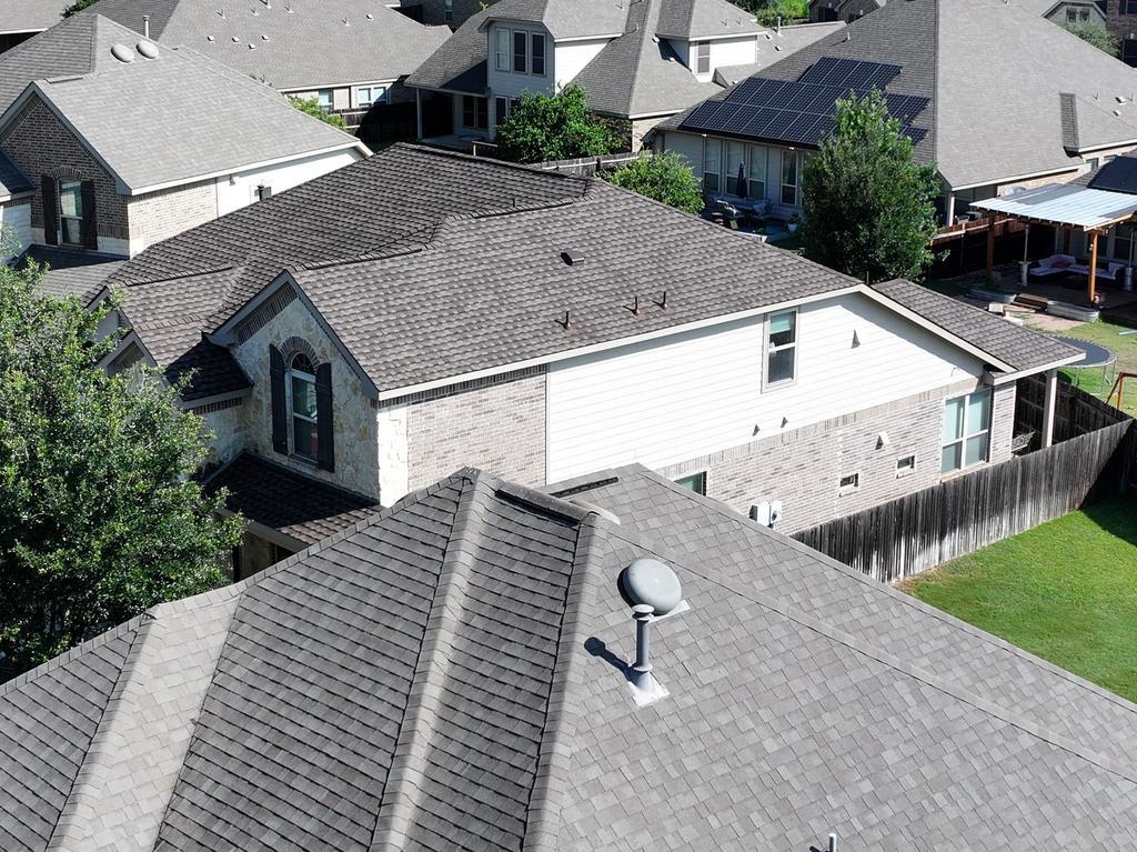 Aerial view of the completed commercial shingle roof at Sunbridge Inn & Suites